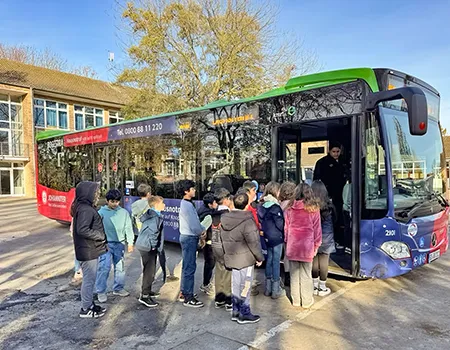 Schüler:innen steigen in einen Bus ein