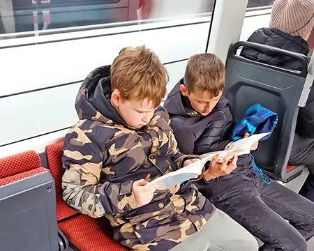 Lesende Kinder auf der Rückfahrt zur Emil-von-Behring-Schule